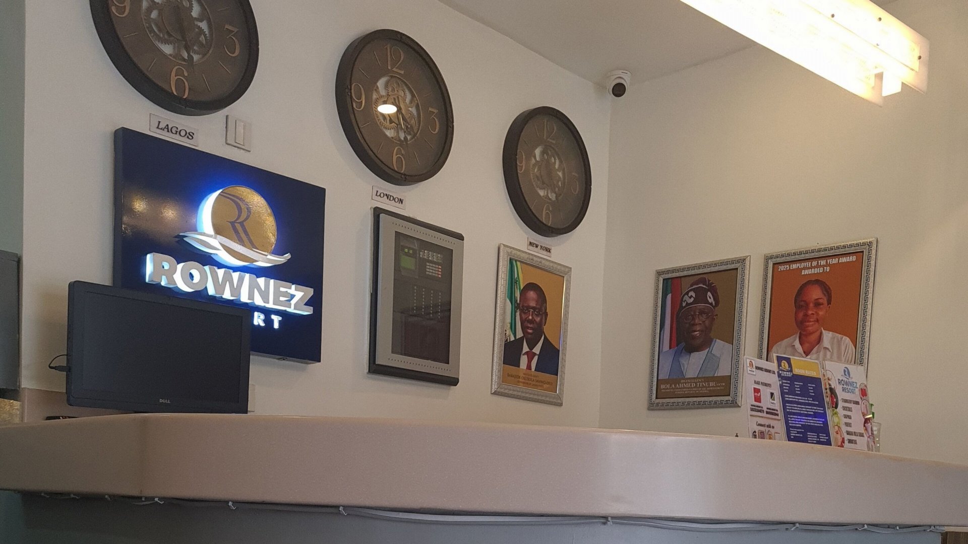 The reception desk, with world clocks and the Rownez sign
