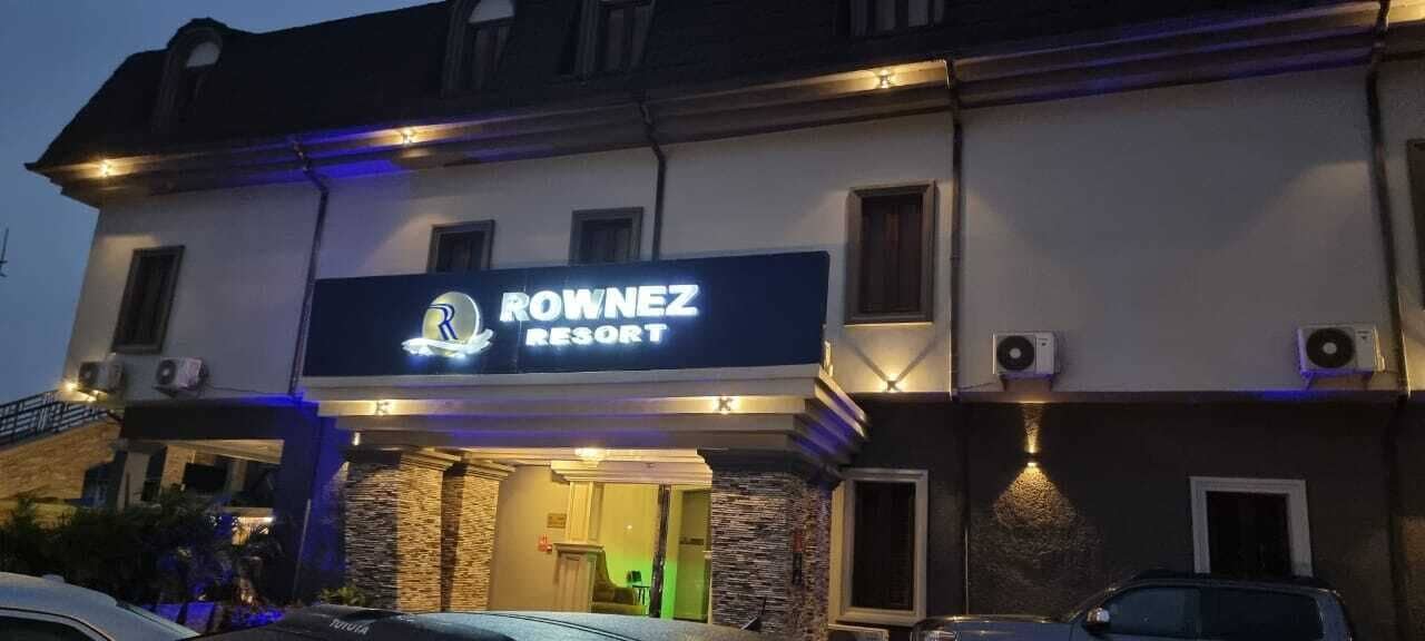 The lit Rownez Resort sign over the entrance at night