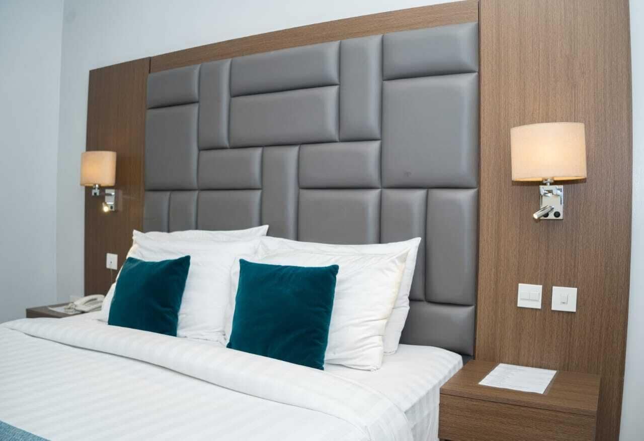 Deluxe Room king bed with upholstered headboard