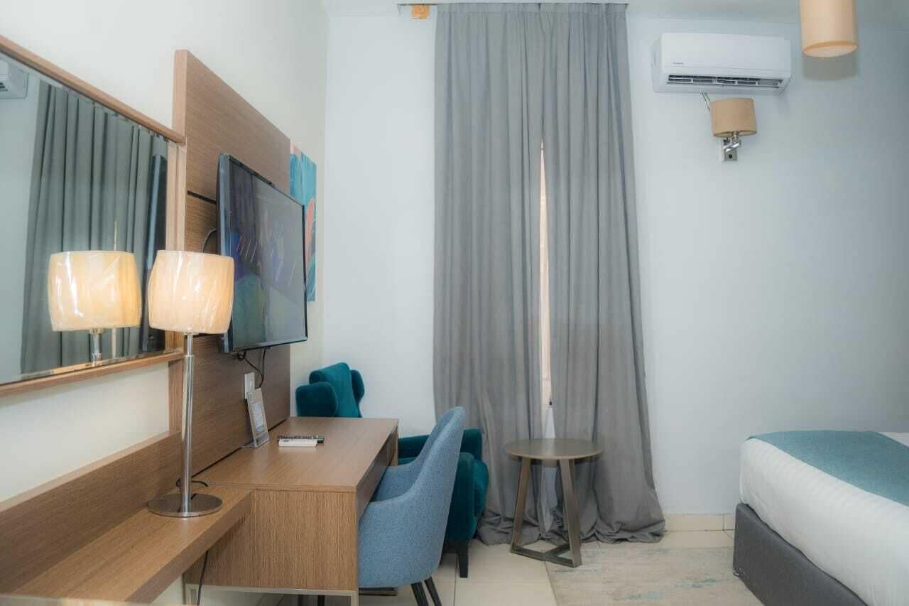 Standard Room with mirror, desk and armchair